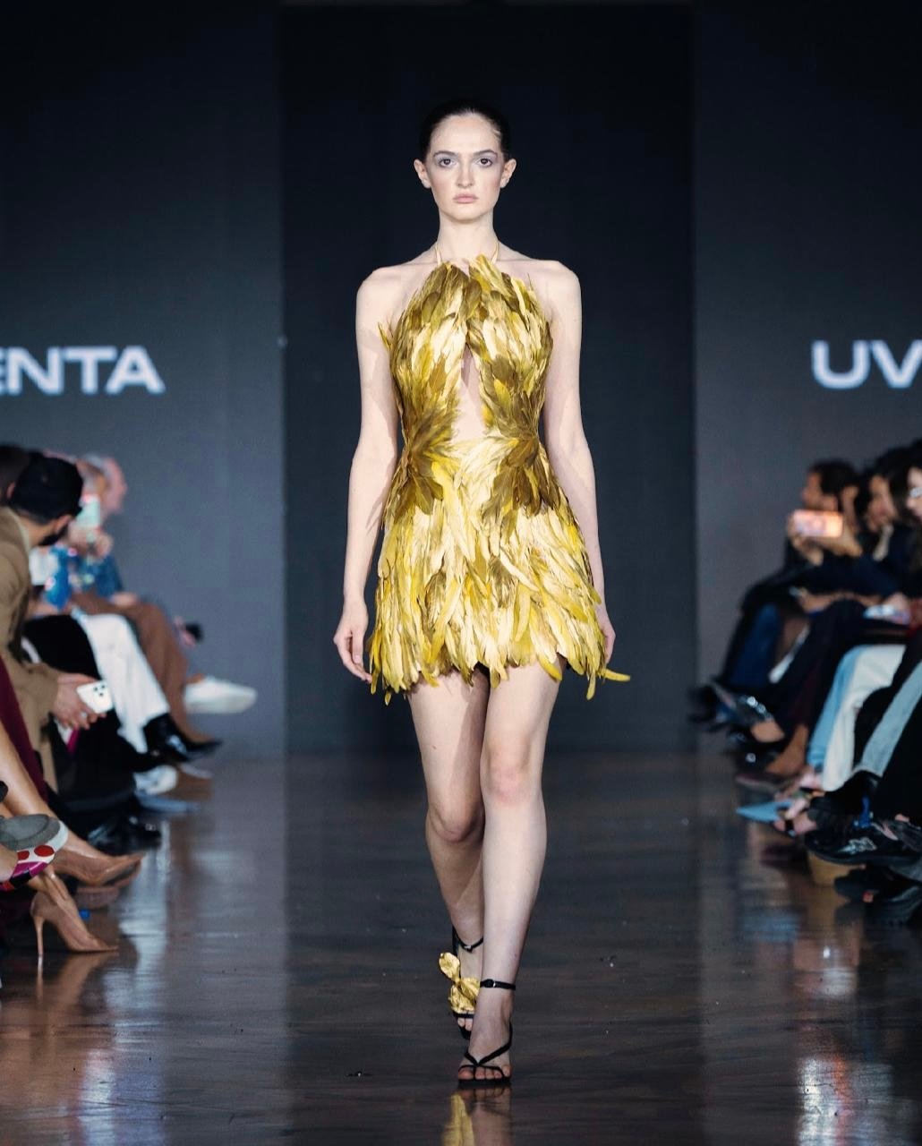 Striking mini dress crafted with layered golden feather detailing
